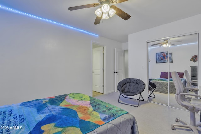 bedroom with a closet, ceiling fan, and light colored carpet