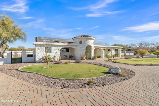 mediterranean / spanish home featuring solar panels