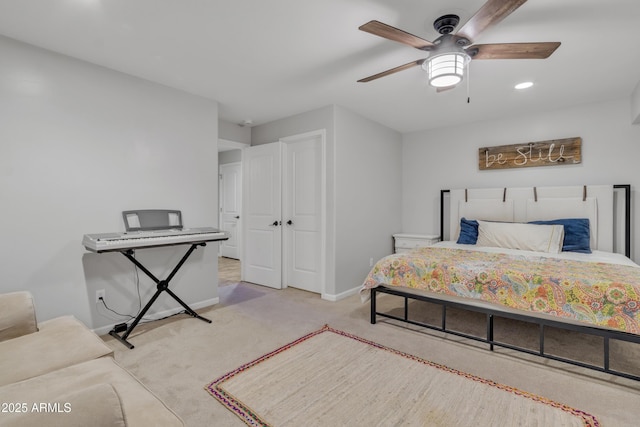 bedroom with light carpet, a closet, and ceiling fan