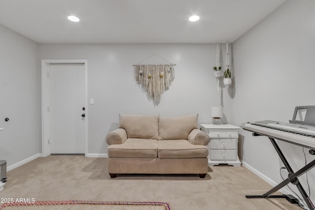 sitting room featuring light colored carpet