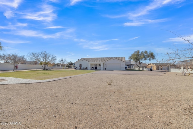 view of front of house with a garage and a front lawn