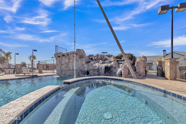 view of pool with pool water feature