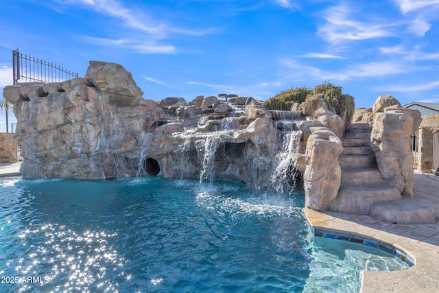 view of pool with pool water feature