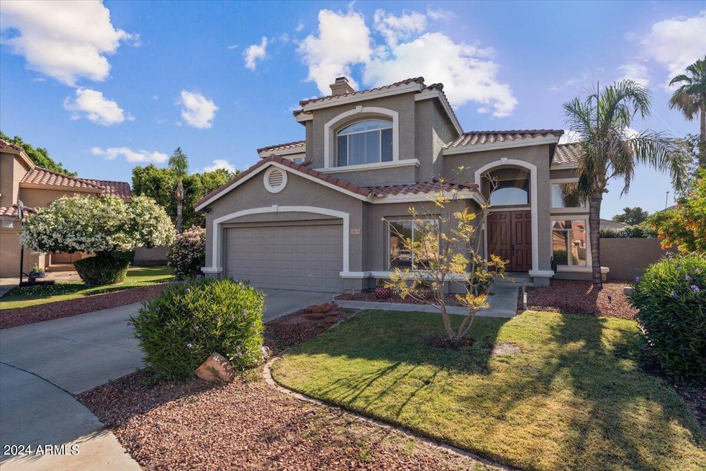 mediterranean / spanish-style house featuring a front lawn