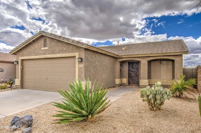 ranch-style house with concrete driveway, an attached garage, and stucco siding