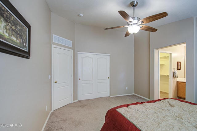 bedroom with a closet, baseboards, carpet, and visible vents