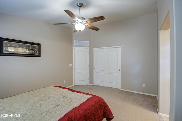 bedroom featuring a closet, visible vents, baseboards, and carpet