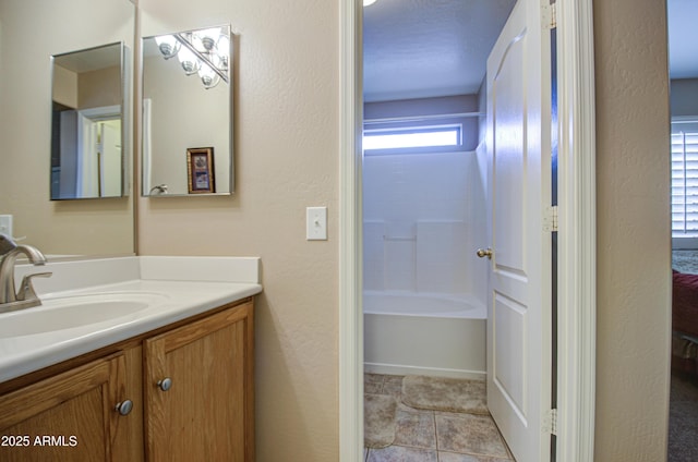 full bathroom featuring vanity, a bathtub, and tile patterned flooring