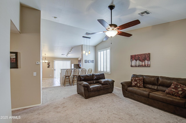 carpeted living room featuring lofted ceiling, baseboards, visible vents, and ceiling fan