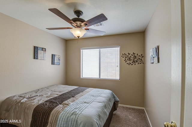 carpeted bedroom with visible vents, baseboards, and ceiling fan