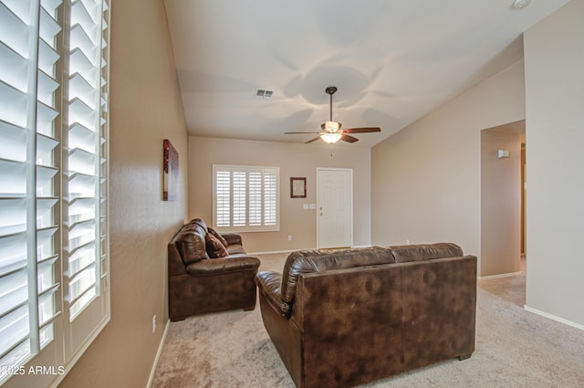 carpeted living area with visible vents, lofted ceiling, baseboards, and ceiling fan