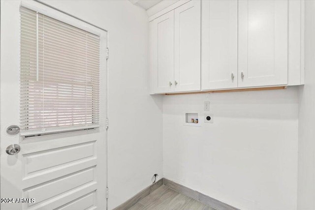 laundry area with baseboards, washer hookup, cabinet space, and hookup for an electric dryer