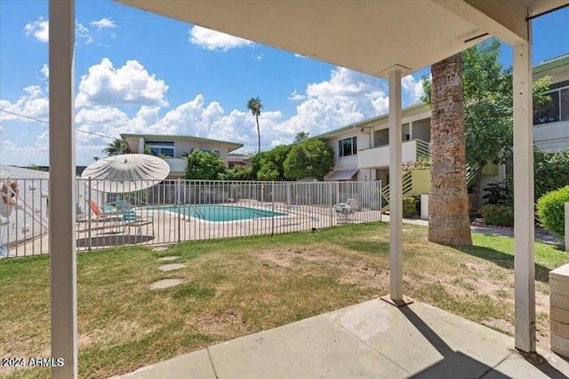 view of swimming pool featuring a fenced in pool, a yard, a patio, and fence