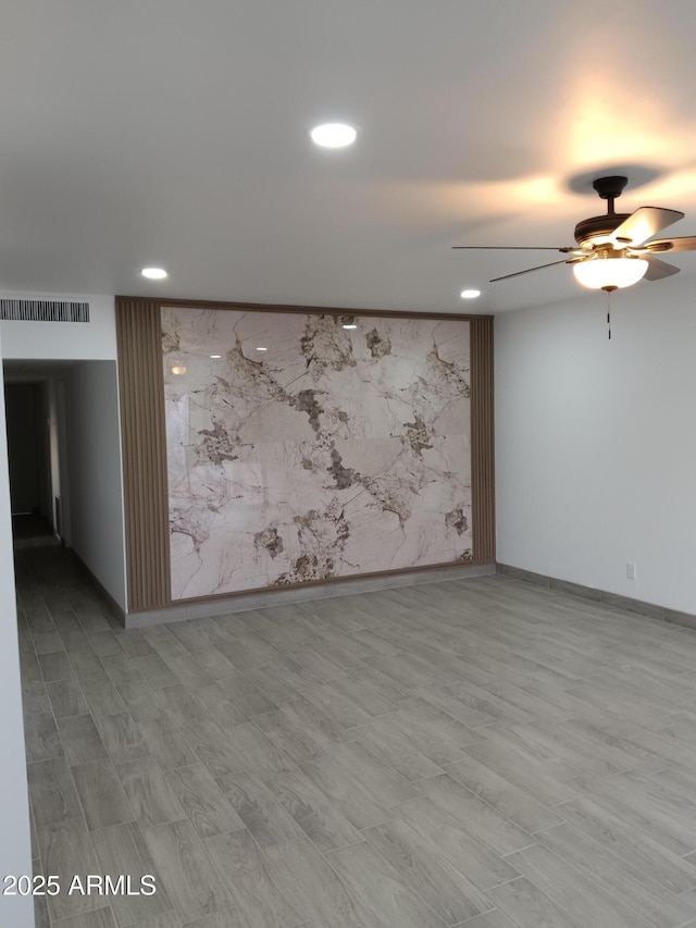 spare room featuring recessed lighting, visible vents, and baseboards