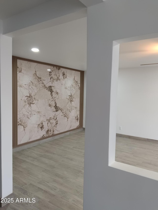 spare room featuring light wood-type flooring, baseboards, and recessed lighting