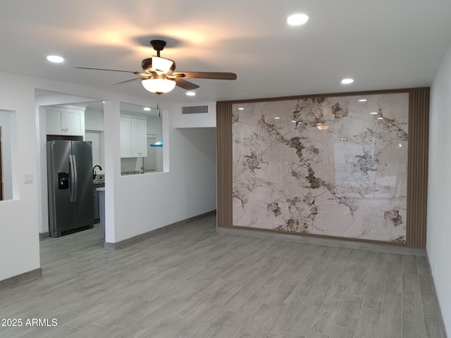 empty room with light wood finished floors, visible vents, a ceiling fan, and recessed lighting