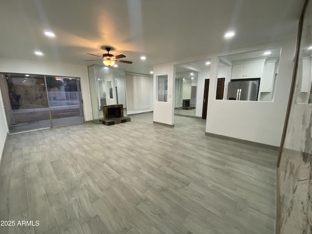 unfurnished living room featuring light wood-style floors, ceiling fan, and recessed lighting