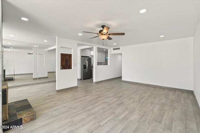 unfurnished living room featuring light wood finished floors, visible vents, baseboards, ceiling fan, and recessed lighting