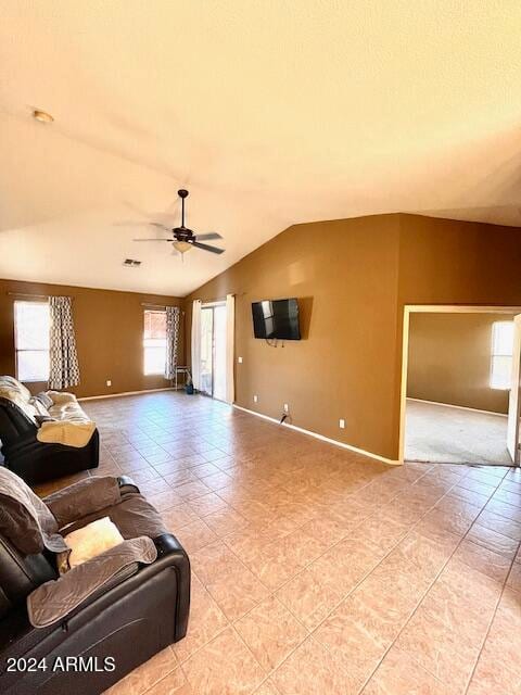 tiled living room featuring vaulted ceiling and ceiling fan