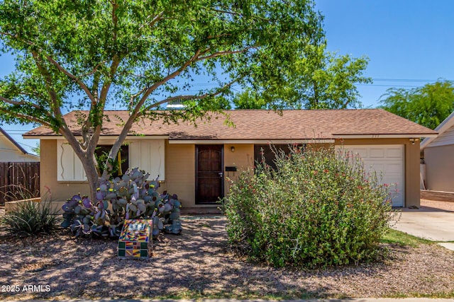 single story home with a garage, fence, and concrete driveway