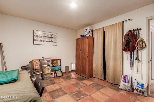 bedroom with stone tile floors