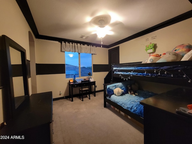 carpeted bedroom featuring ceiling fan and ornamental molding