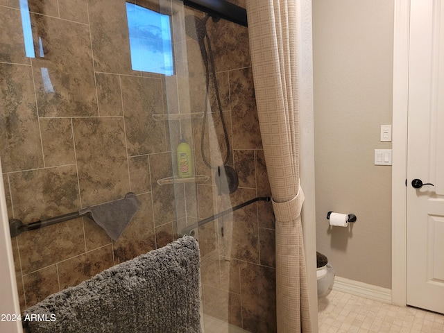 bathroom with a shower with shower curtain and toilet