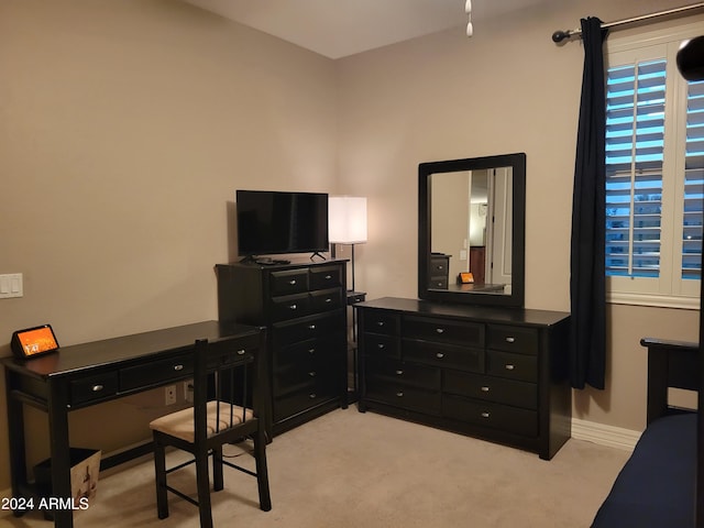 office area featuring light carpet and baseboards