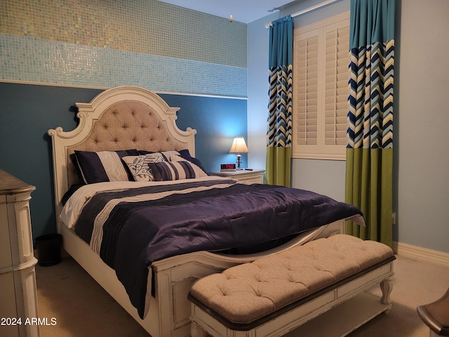 bedroom featuring carpet and baseboards