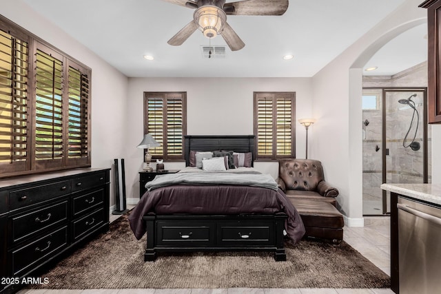 tiled bedroom featuring arched walkways, recessed lighting, visible vents, and baseboards