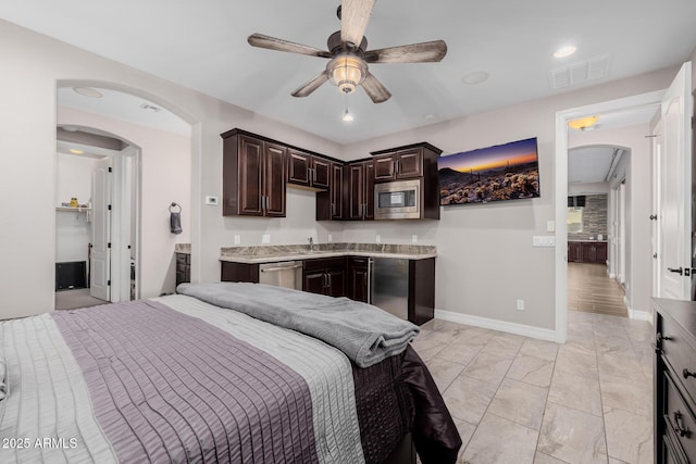 bedroom with baseboards, visible vents, arched walkways, and recessed lighting