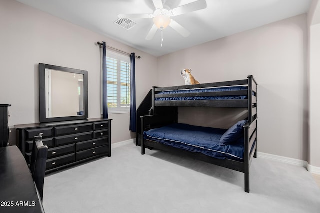 carpeted bedroom featuring ceiling fan, visible vents, and baseboards