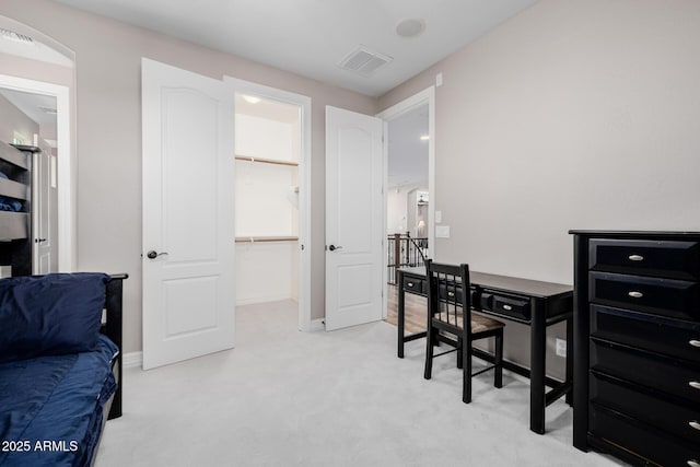 office area featuring light carpet, visible vents, and baseboards