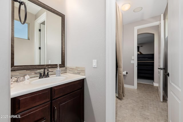 bathroom featuring vanity and decorative backsplash