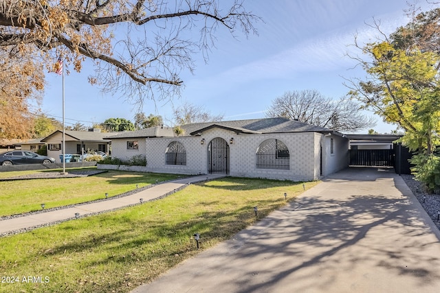 ranch-style home with a front yard and a carport