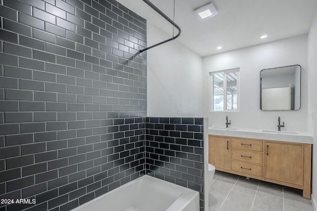 full bathroom featuring tiled shower / bath combo, vanity, tile patterned floors, and toilet