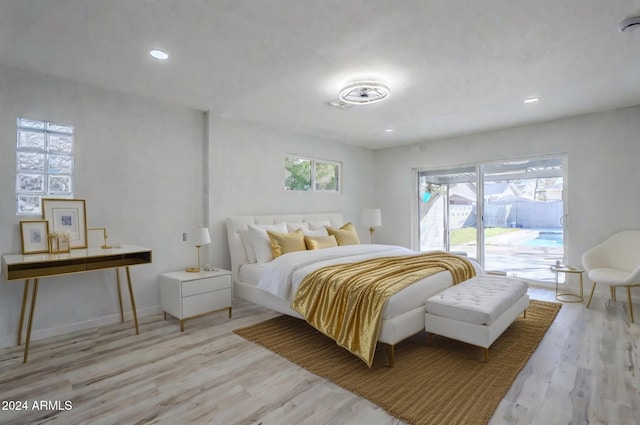 bedroom featuring access to exterior and light hardwood / wood-style flooring