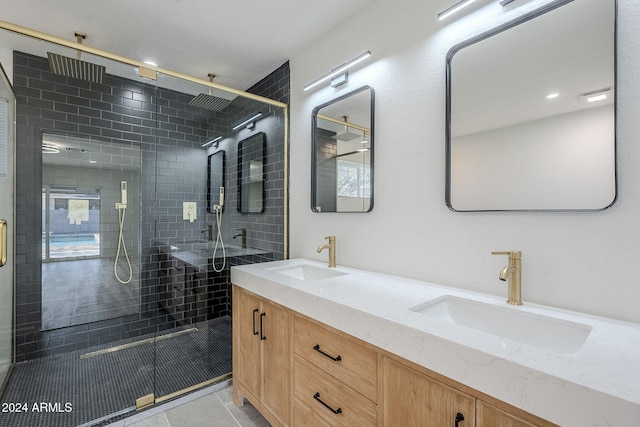 bathroom with tile patterned floors, vanity, and a shower with shower door