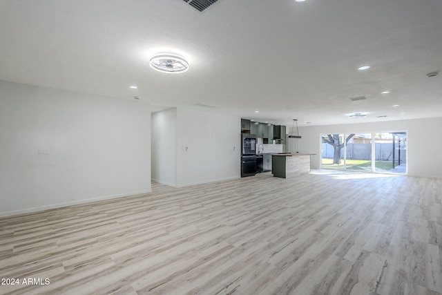 unfurnished living room featuring light wood-type flooring