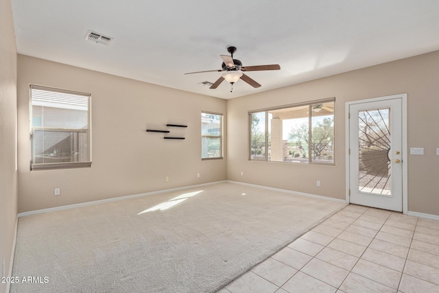 unfurnished room featuring ceiling fan and light carpet