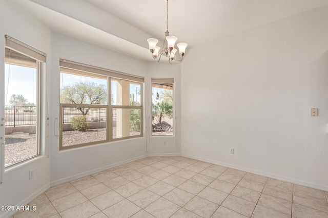 tiled empty room with a notable chandelier