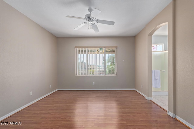 empty room featuring hardwood / wood-style floors and ceiling fan