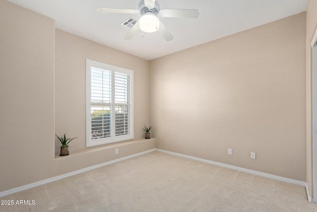 spare room with light colored carpet and ceiling fan