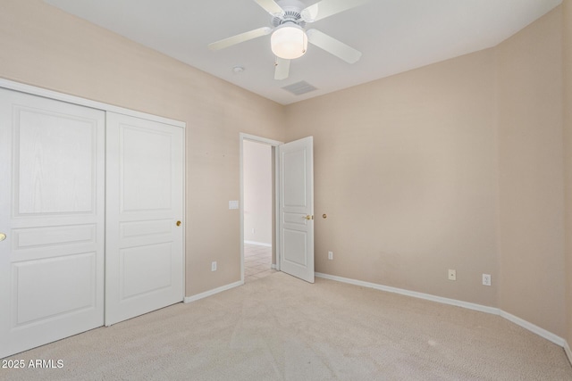 unfurnished bedroom with light carpet, a closet, and ceiling fan