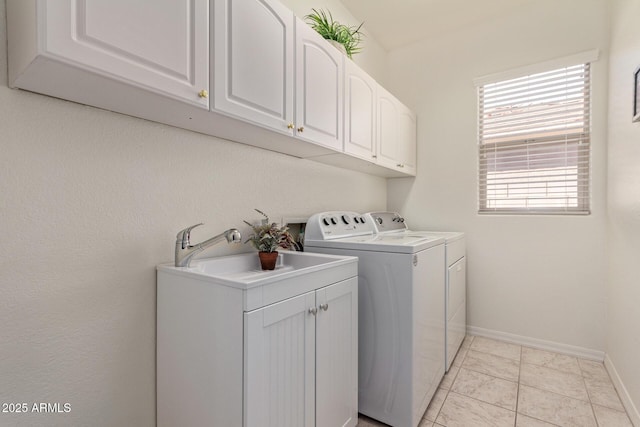 laundry room featuring cabinets, washing machine and dryer, and sink