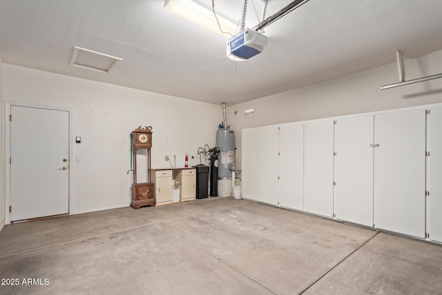 garage with a garage door opener and water heater