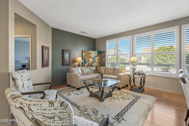 living room with hardwood / wood-style flooring and vaulted ceiling