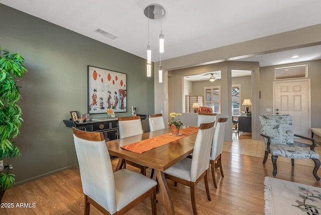 dining space featuring ceiling fan and light hardwood / wood-style floors