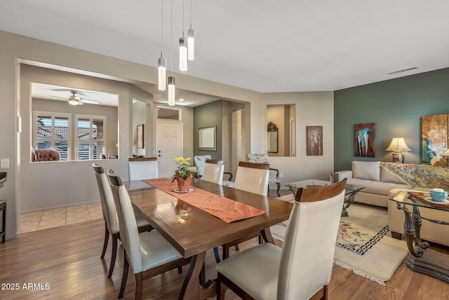 dining space featuring ceiling fan and light hardwood / wood-style flooring