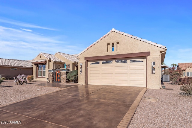 view of front of property with a garage and central air condition unit